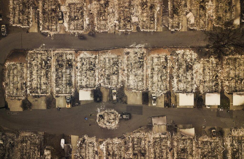 In this on Thursday, Nov. 15, 2018 file photo, residences leveled by the wildfire line a neighborhood in Paradise, Calif. (AP Photo/Noah Berger)