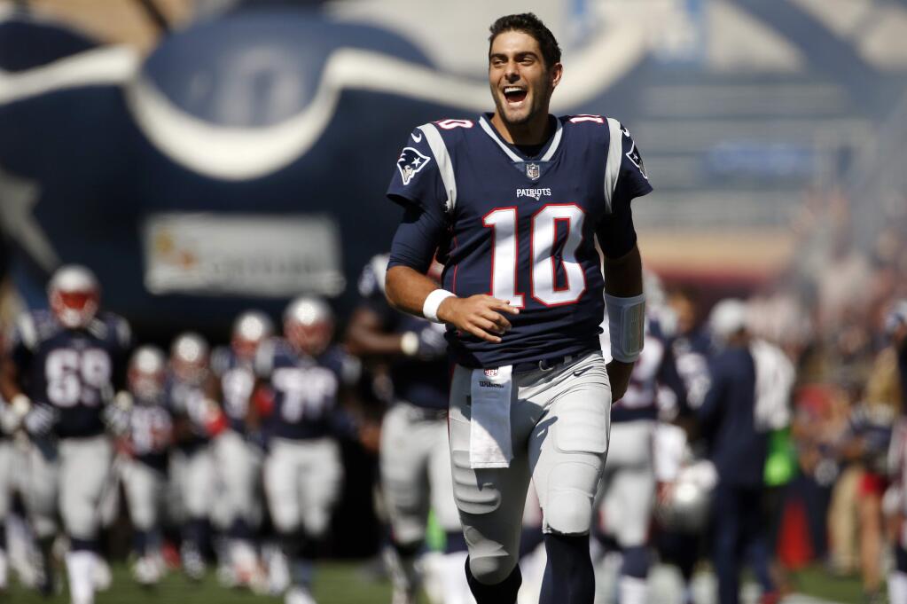 In this Sunday, Sept. 24, 2017 file photo, New England Patriots quarterback Jimmy Garoppolo charges onto the field before a game against the Houston Texans in Foxborough, Mass. On Monday, the Patriots traded Garoppolo to the San Francisco 49ers for a 2018 draft pick. (AP Photo/Michael Dwyer, File)