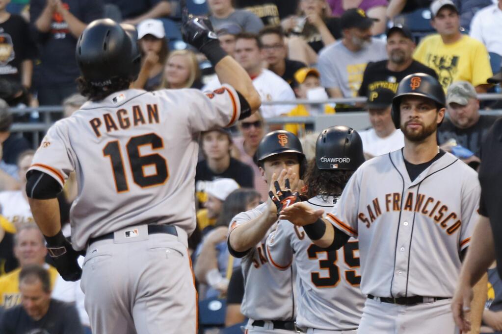 San Francisco Giants' Angel Pagan (16) is greeted by Brandon Belt, right, as other teammates celebrate after Pagan hit a grand slam against the Pittsburgh Pirates during the fourth inning of a baseball game, Tuesday, June 21, 2016, in Pittsburgh. (AP Photo/Keith Srakocic)