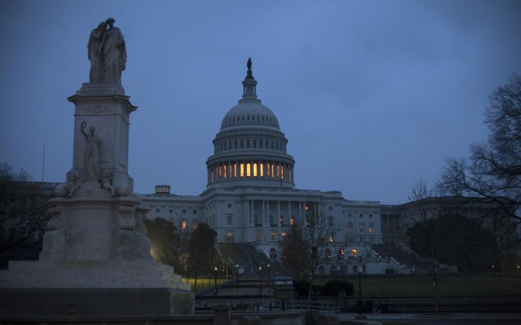 The Capitol is seen early Tuesday, March 20, 2018 in Washington. Two major issues, the border wall and a tunnel and rail project, are holding up the massive government-wide spending bill that must pass Congress before a midnight Friday deadline to avoid another government shutdown. An agreement could be announced as early as today. (AP Photo/J. Scott Applewhite)