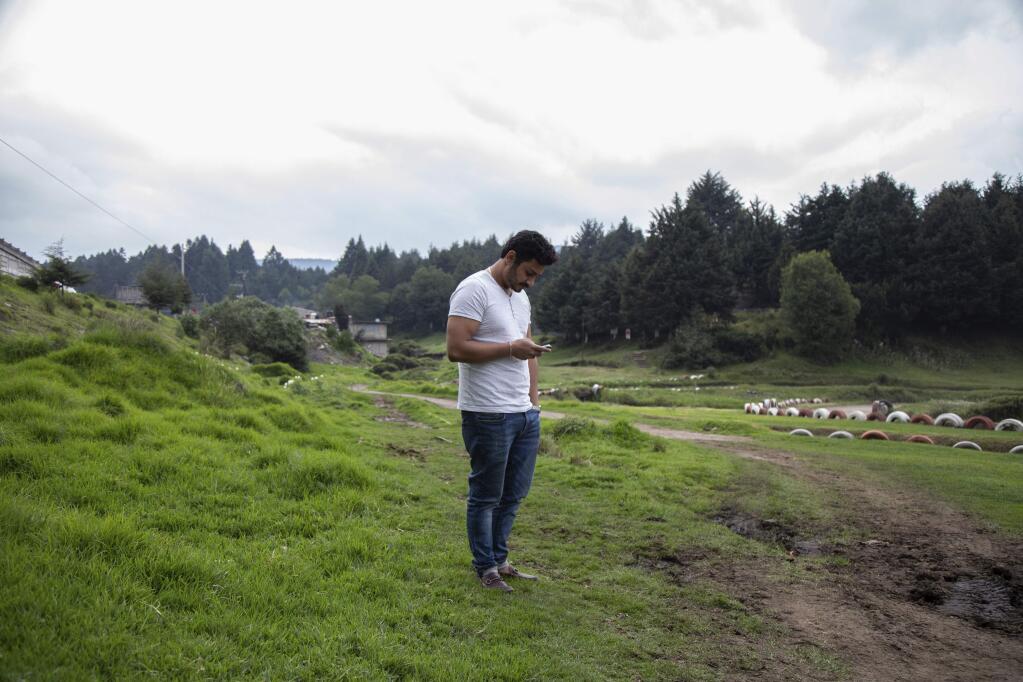 Bernardo Reyes Rodriguez checks his phone for messages in La Marquesa, Mexico, Saturday, June 30, 2018. Rodriguez is looking for answers after being arrested by immigration officers whilst pending review for a U visa for him and his wife. Under past presidents, people who were here illegally but qualify for a U visa were usually allowed to wait stateside until their petition was approved. But now ramped-up immigration enforcement has meant that some of them are getting swept up by U.S. Immigration and Customs Enforcement before they have a chance to legalize. (AP Photo/Anthony Vazquez)