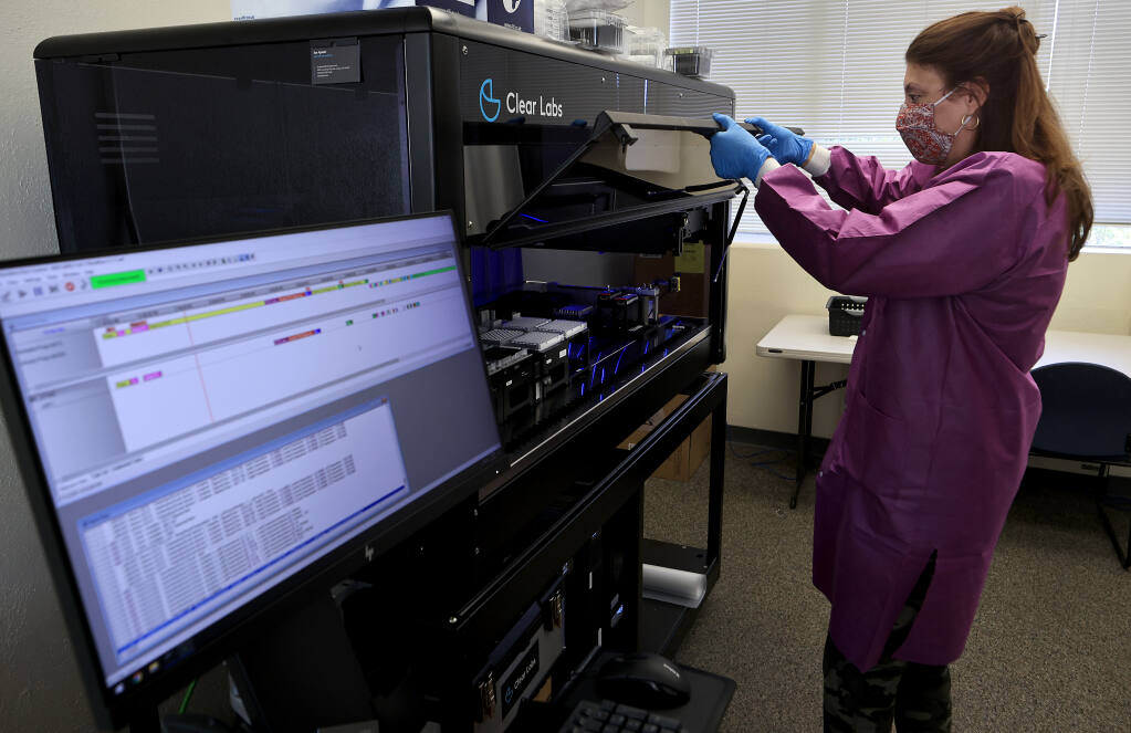 Lisa Critchett, a county health microbiologist checks the progress of genetic sequencing for COVID-19 testing samples in state of the art genotyping equipment, Tuesday, July 13, 2021, at Sonoma County Public Health in Santa Rosa. (Kent Porter / The Press Democrat)