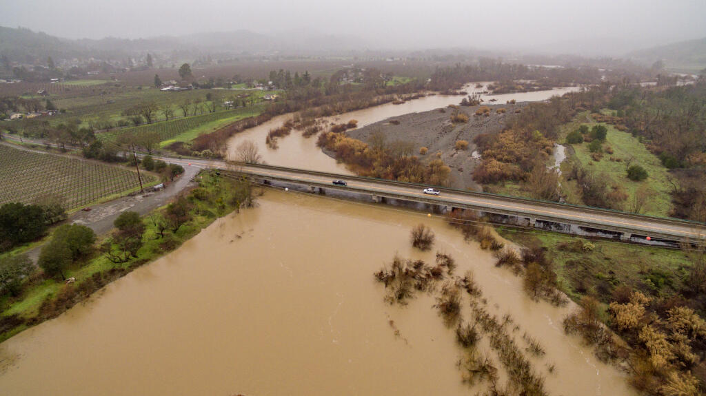 Highway 128 crosses a full Russian River near Geyserville as drizzle continues to fall after recent atmospheric rivers left Sonoma County waterlogged with more rain forecast for the weekend. Photo taken Friday, Jan. 6, 2023. (Chad Surmick/The Press Democrat)