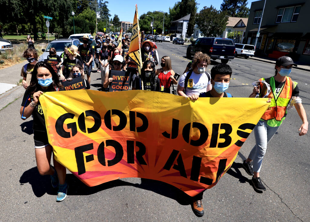 Sunrise Movement activists led by Ema Govea,17, left, of Santa Rosa start the next leg of their walk to complete a 266-mile journey between Paradise and San Francisco, Thursday, June 10, 2021, in Santa Rosa.  (Kent Porter / The Press Democrat) 2021