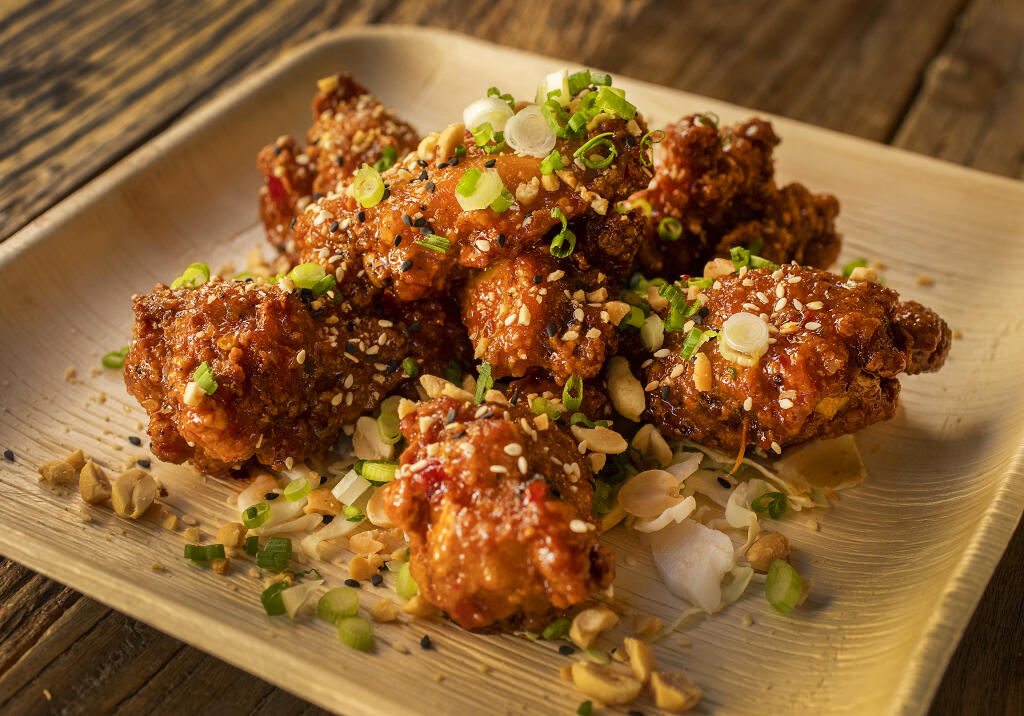 Spicy Sweet Chile Chicken Wings are sprinkled with peanuts, scallions and sesame seeds at The Mill at Glen Ellen. (John Burgess/The Press Democrat)