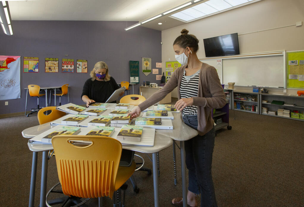 The Presentation School’s eighth-grade teacher Natalie Rentz, right, prepares her classroom for students, with some help from Head of School Jacqueline Gallo, on Thursday, Oct. 8. (Photo by Robbi Pengelly/Index-Tribune)