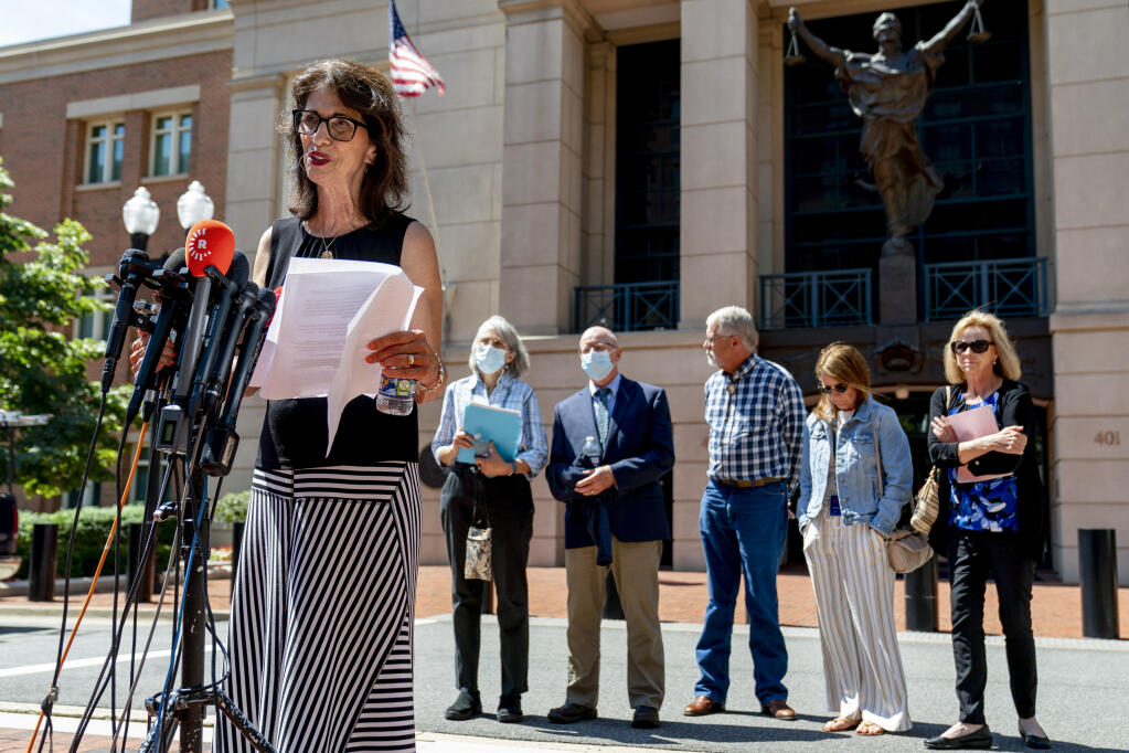 Diane Foley, mother of James Foley, foreground, accompanied by from left, Paula and Ed Kassig, the parents of Peter Kassig, Marsha Mueller, the mother Kayla Mueller and her sister Lori Lyon, speaks to members of the media after the sentencing of El Shafee Elsheikh at the U.S. District Courthouse in Alexandria, Va., Friday, Aug. 19, 2022. Elsheikh, who was sentenced to life in prison, was convicted on April 14, 2022 of kidnapping and murdering freelance journalist James Foley as well as participating in the detention and murders of Steven Sotloff, Kayla Mueller and Peter Kassig, all in 2014. (AP Photo/Andrew Harnik)