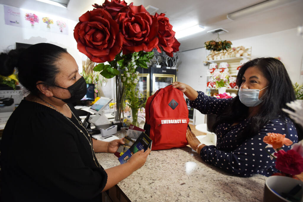 "If you don't have one, you need one," said, Sally Lopez, right, of Small Business Hardship Fund Sonoma County dropping off a free emergency preparedness kit for business owner Bertha Barajas, left, at Bevess Floral shop in Santa Rosa, Calif. on Friday, June 4, 2021. Businesses that have 15 employees or less are eligible for a free kit.(Photo: Erik Castro/for The Press Democrat)