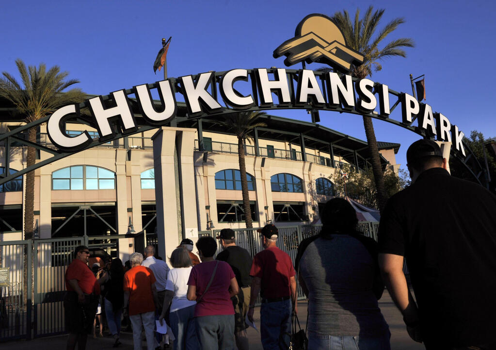 FILE - In this Sept. 18, 2015, file photo, fans arrive at Chukchansi Park in Fresno, Calif., for a minor-league baseball game between the Fresno Grizzlies and the Round Rock Express. Fresno authorities say a man died shortly after competing in a taco-eating contest at a Grizzlies game. The son of a California man who choked to death during the amateur taco eating contest at a minor league baseball game is suing the event's organizers for negligence. (Eric Paul Zamora/The Fresno Bee via AP, File)