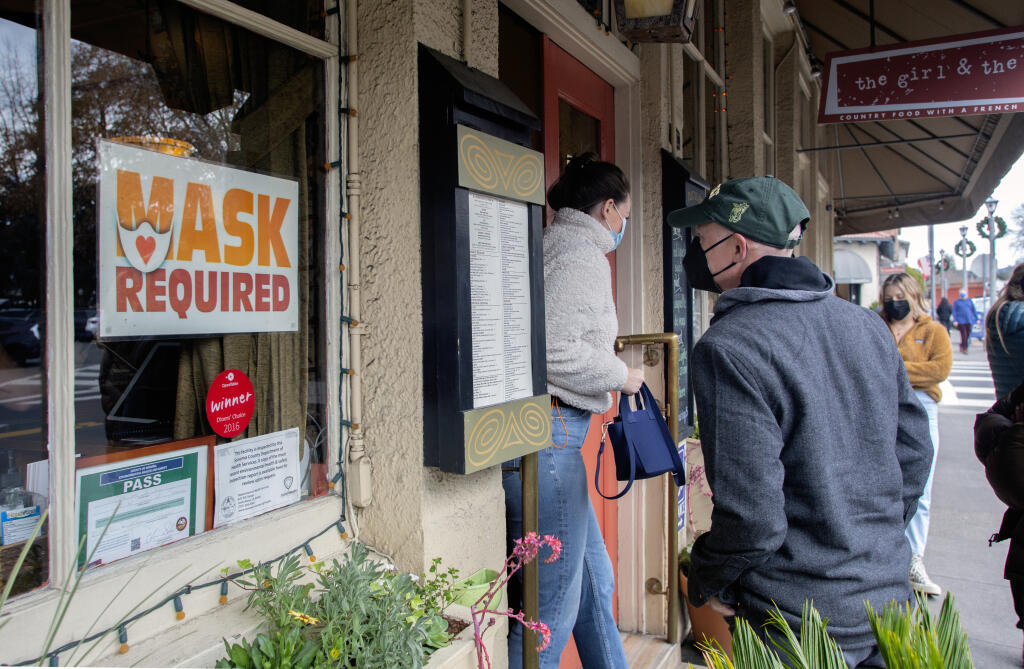 A ‘Mask Required’ sign in the window of Girl and the Fig on the corner of First Street West and West Spain Street in Sonoma, Calif. on Thursday, 30 Dec., 2021. (Robbi Pengelly/Index-ribune)