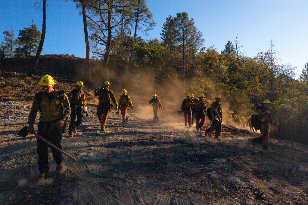 Members of a Cal Fire hand crew file out from a bulldozer line into a ridgeline clearing at Robert Louis Stevenson State Park to prepare for an operation during the Glass fire, near Calistoga, California, on Saturday, Oct. 3, 2020. (Alvin A.H. Jornada / The Press Democrat)