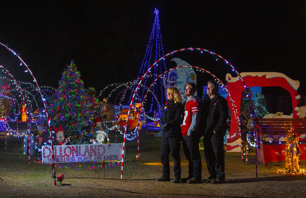 From left, Karen, Dillon and Gary Stall at their Christmas themed, walk-through holiday fantasyland on Grove Street, on Wednesday, Dec. 2. (Photo by Robbi Pengelly/Index-Tribune)