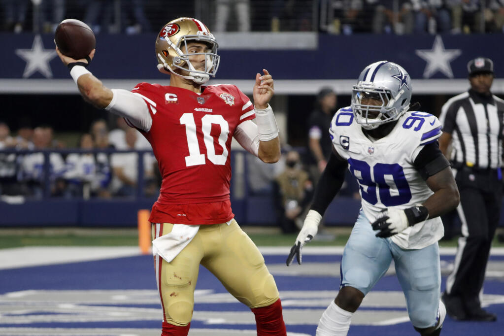 San Francisco 49ers quarterback Jimmy Garoppolo throws a pass under pressure from Dallas Cowboys defensive end Demarcus Lawrence during the second half  in Arlington, Texas, on Sunday, Jan. 16, 2022. (Roger Steinman / ASSOCIATED PRESS)
