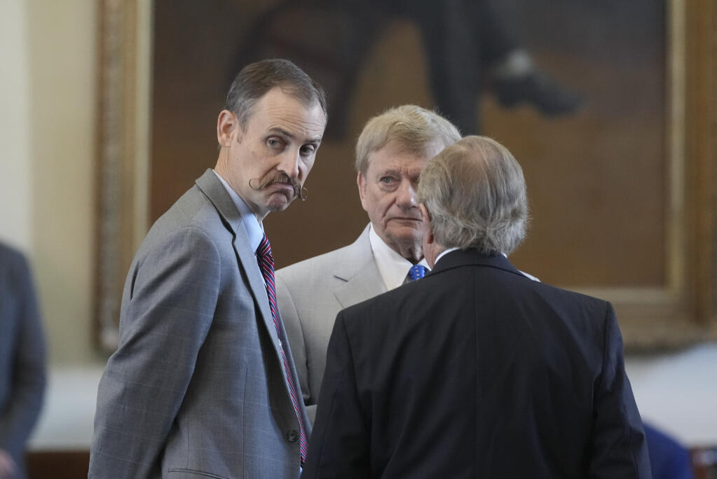 House impeachment manager Andrew Murr talks with attorneys Rusty Hardin and Dick DeGuerin before the morning session of Texas Attorney General Ken Paxton's impeachment trial in the Texas Senate in Austin, Texas, Sept. 6, 2023.(Bob Daemmrich/The Daily Tribune via AP, Pool)