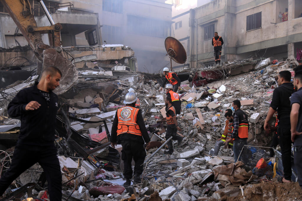 Rescue workers search for victims from the al-Qawlaq family after an Israeli air strike in Gaza City on May 16, 2021. During 11 days of fighting between Israel and Hamas, at least 66 children under age 18 were killed in Gaza and two in Israel, according to initial reports. (SAMAR ABU ELOUF/THE NEW YORK TIMES)