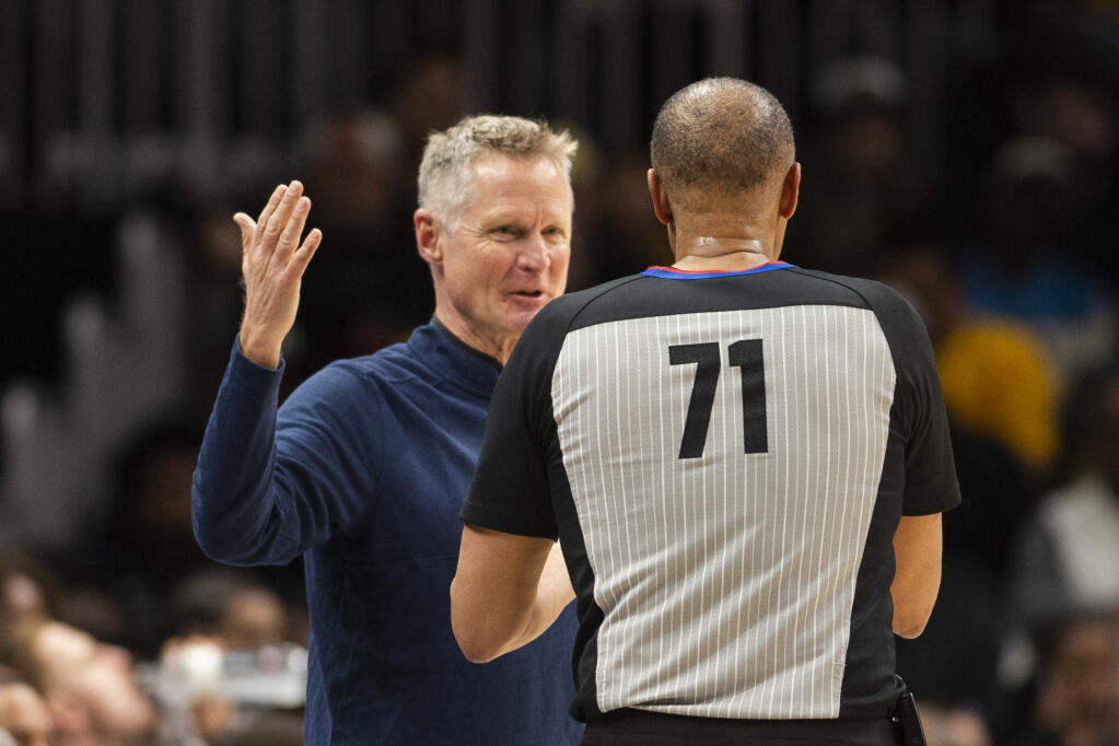 Golden State Warriors head coach Steve Kerr, left, speaks with referee Rodney Mott during the second half against the Hawks, Friday, March 17, 2023, in Atlanta. (Hakim Wright Sr. / ASSOCIATED PRESS)