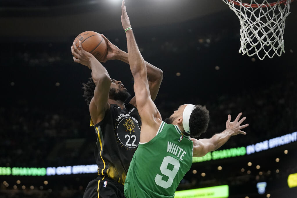 Golden State Warriors forward Andrew Wiggins looks to shoot at the basket past Celtics guard Derrick White in the first half Thursday in Boston. (Steven Senne / ASSOCIATED PRESS)