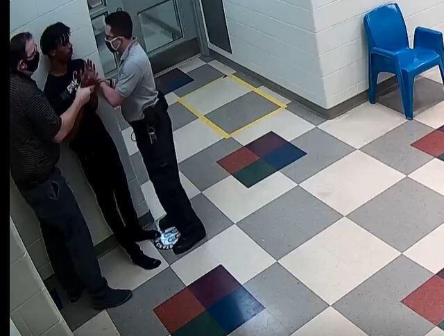 This still image from a security camera provided by Sedgwick County shows Cedric "CJ" Lofton struggling with staff on Sept. 24, 2021 at the Sedgwick County Juvenile Intake and Assessment Center in Wichita, Kan.  Sedgwick County released 18 video clips late Friday, Jan. 21, 2022, of what happened before Lofton was rushed to a hospital on Sept. 24. He died two days later.  (Sedgwick County via AP)