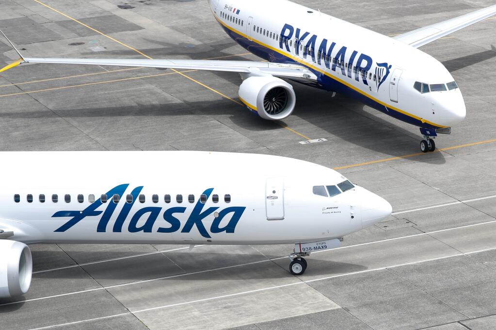 An Alaska Airlines 737-9 sits next to a Ryanair 737-8-200 outside Boeing's Seattle Delivery Center at Boeing Field, Tuesday, June 14, 2022, in Seattle. (Jennifer Buchanan/The Seattle Times via AP, Pool)
