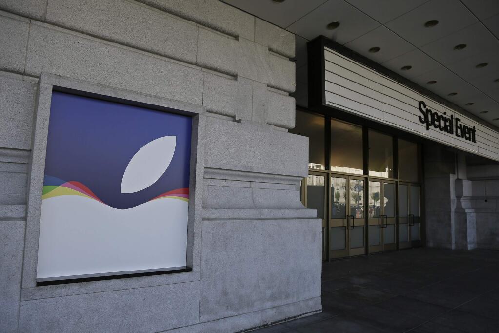 This photo shows the exterior of the Bill Graham Civic Auditorium as preparations continue inside for the Apple product announcement Tuesday, Sept. 8, 2015, in San Francisco. Along with new iPhones, the iconic tech company is expected to show off a new Apple TV system and a bigger role in the home for Siri, its voice-activated digital assistant. (AP Photo/Eric Risberg)