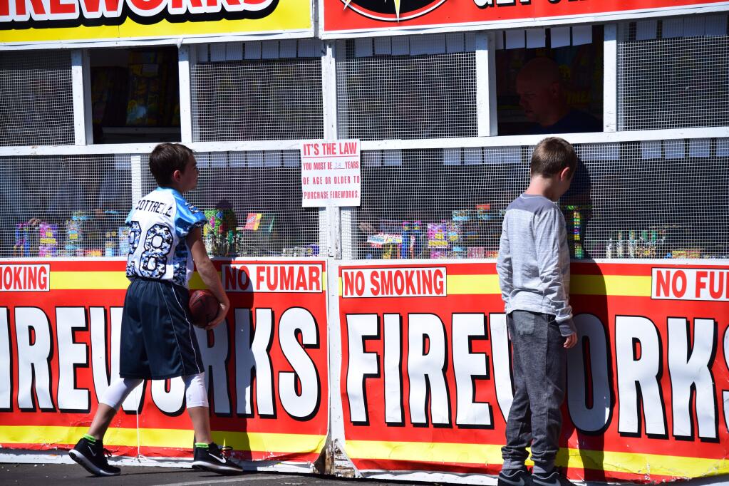 Boys check out the display of fireworks at this stand in Rohnert Park, opened Friday, June 30. (James Dunn / North Bay Business Journal)