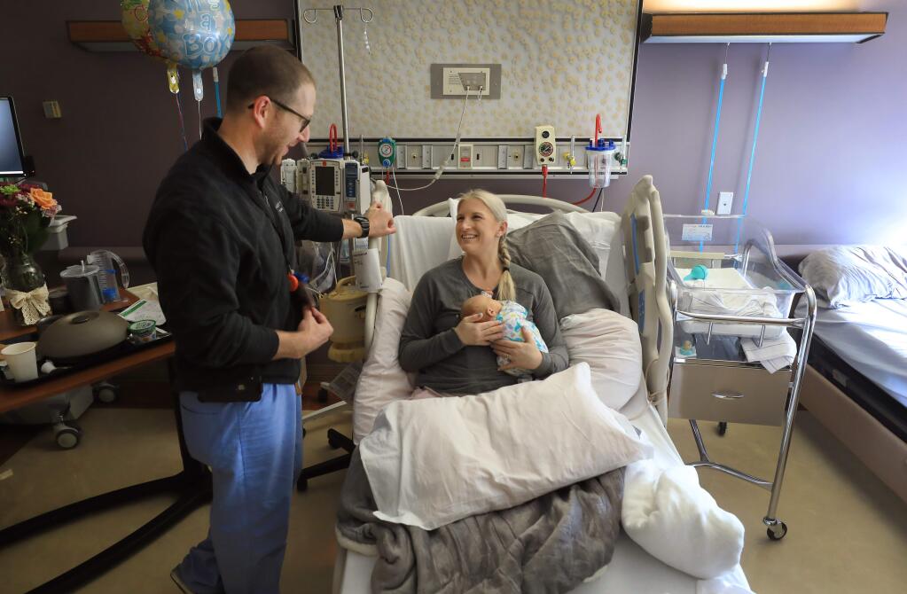 Ob-gyn Dr. Jonathan Kurss makes a follow up visit to new mother Jennifer Swaney and her son Jax at Memorial Hospital in Santa Rosa, Friday, Feb. 8, 2018. Kurss believes in frequent screening for pregnant and new mothers for postpartum depression. (Kent Porter / Press Democrat) 2019
