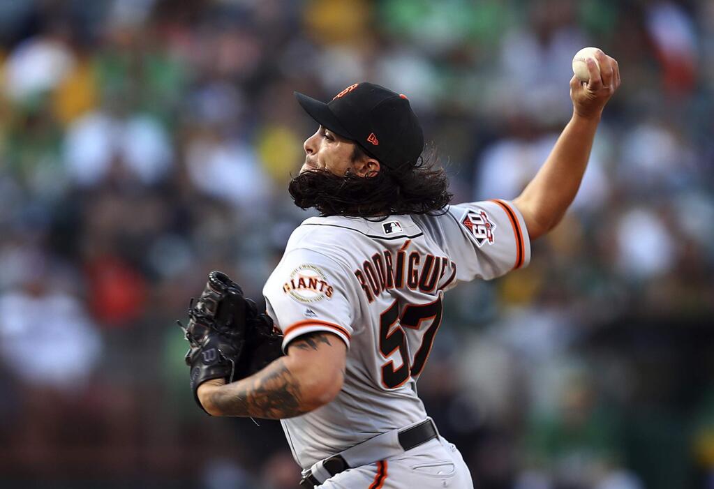 San Francisco Giants pitcher Dereck Rodriguez works against the Oakland Athletics in the first inning Friday, July 20, 2018, in Oakland. (AP Photo/Ben Margot)