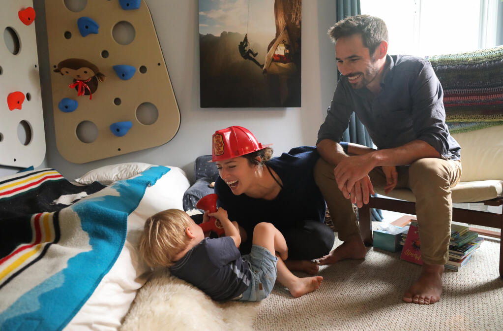 Jacqui and Kevin Jorgeson play with their 22-month-old son, Edsel, at home in Santa Rosa on Friday, Oct. 2, 2020. Jacqui Jorgeson is the founder of the Volunteer Fire Foundation. (Christopher Chung / The Press Democrat)