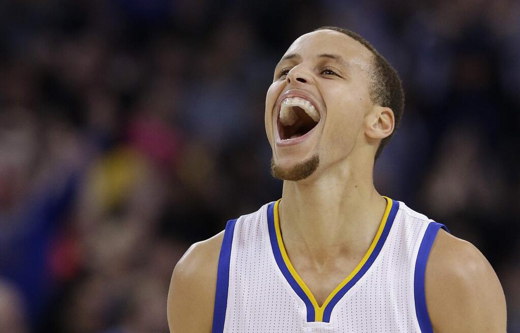 Golden State Warriors guard Stephen Curry celebrates after scoring against the Houston Rockets during the first half of an NBA basketball game in Oakland, Wednesday, Jan. 21, 2015. The Warriors won 126-113. (AP Photo/Jeff Chiu)