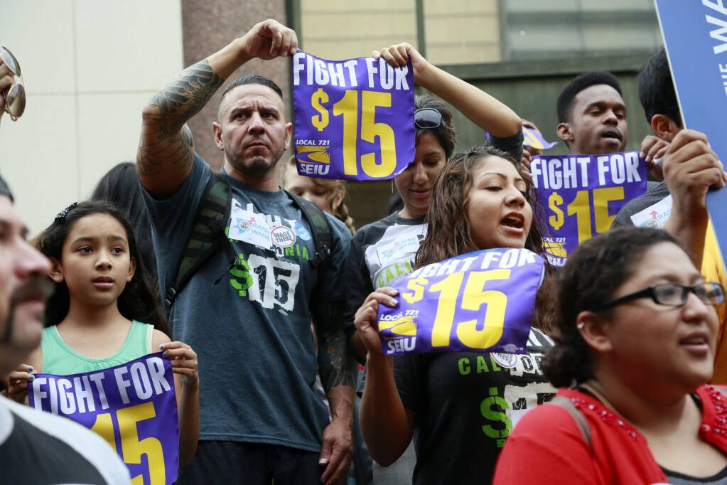 As of Jan. 1, California’s minimum wage will increase to $15 per hour or $14 per hour, depending on the number of workers at a given business. (AP Photo/Nick Ut--File July 21, 2015)