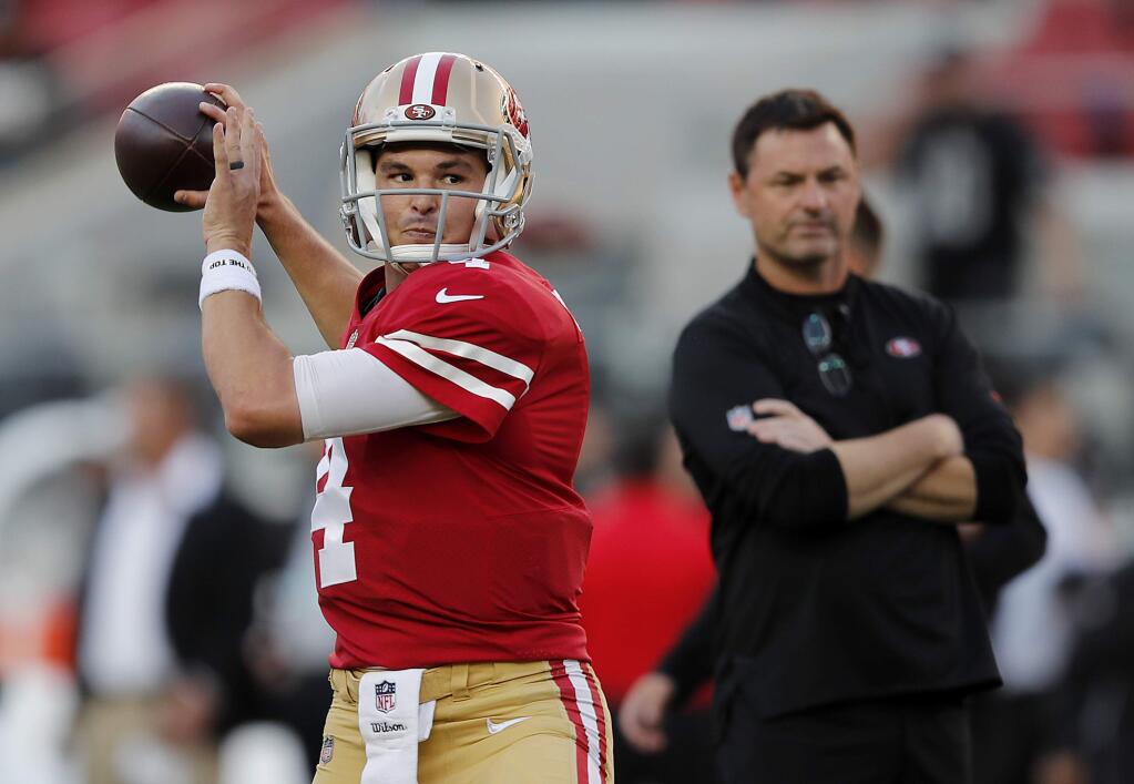 San Francisco 49ers quarterback Nick Mullens, left, warms up in front of assistant coach Rich Scangarello before a game against the Raiders in Santa Clara, Thursday, Nov. 1, 2018. (AP Photo/John Hefti)