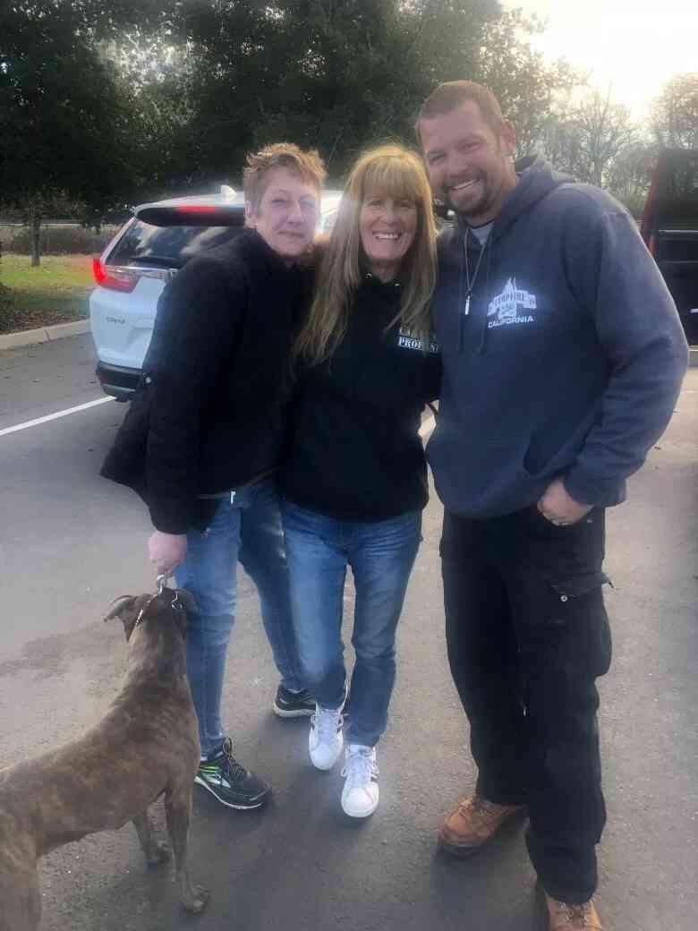 Camp Fire survivor Pam Calli with her dog Nel (left) received a propane tank hand delivered in Oroville on Feb. 9 by Jocelyn Cronin (center) and Stephen Murray (right).