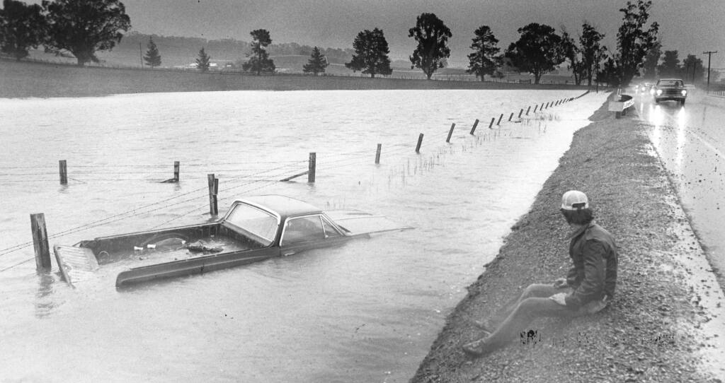 Dave Fothergill of Little River was northbound on Lakeville Road in Petaluma when his truck hit a puddle and hydroplaned, ending up in the water, on Jan. 26, 1983. (Timothy Baker/The Press Democrat)