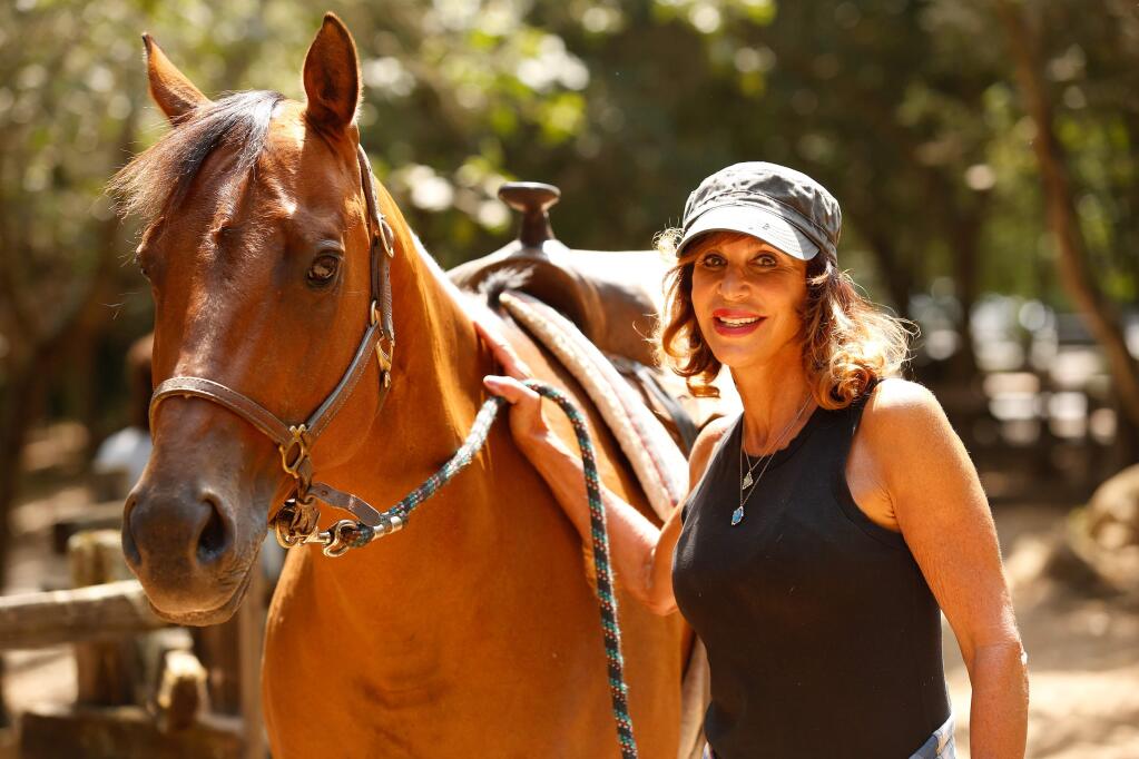 Linda Aldrich poses for a portrait with her horse Peanut at the Pony Express rides at Howarth Park in Santa Rosa, California, on Thursday, August 3, 2017. (Alvin Jornada / The Press Democrat)
