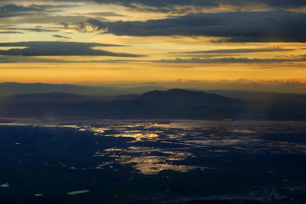 Mount Diablo is silhouetted as the sun rises above the Sacramento River delta. (DON BARTLETTI / Los Angeles Times)