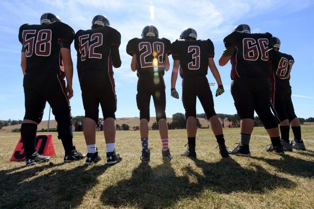 Players on the Tomales High School football team before the start of their first game of the 2015 season against Mendocino High Schoolat Tomales. (Erik Castro / for The Press Democrat)