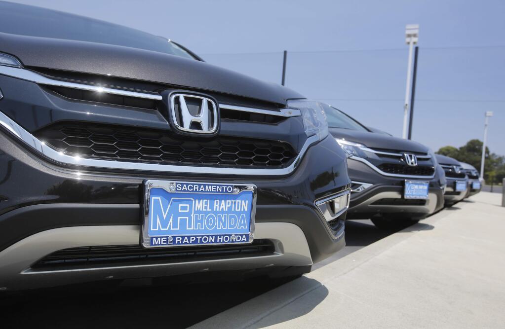 Gov. Jerry Brown signed signed legislation Monday requiring that newly purchased vehicles display temporary license plates. (RICH PEDRONCELLI / Associated Press)