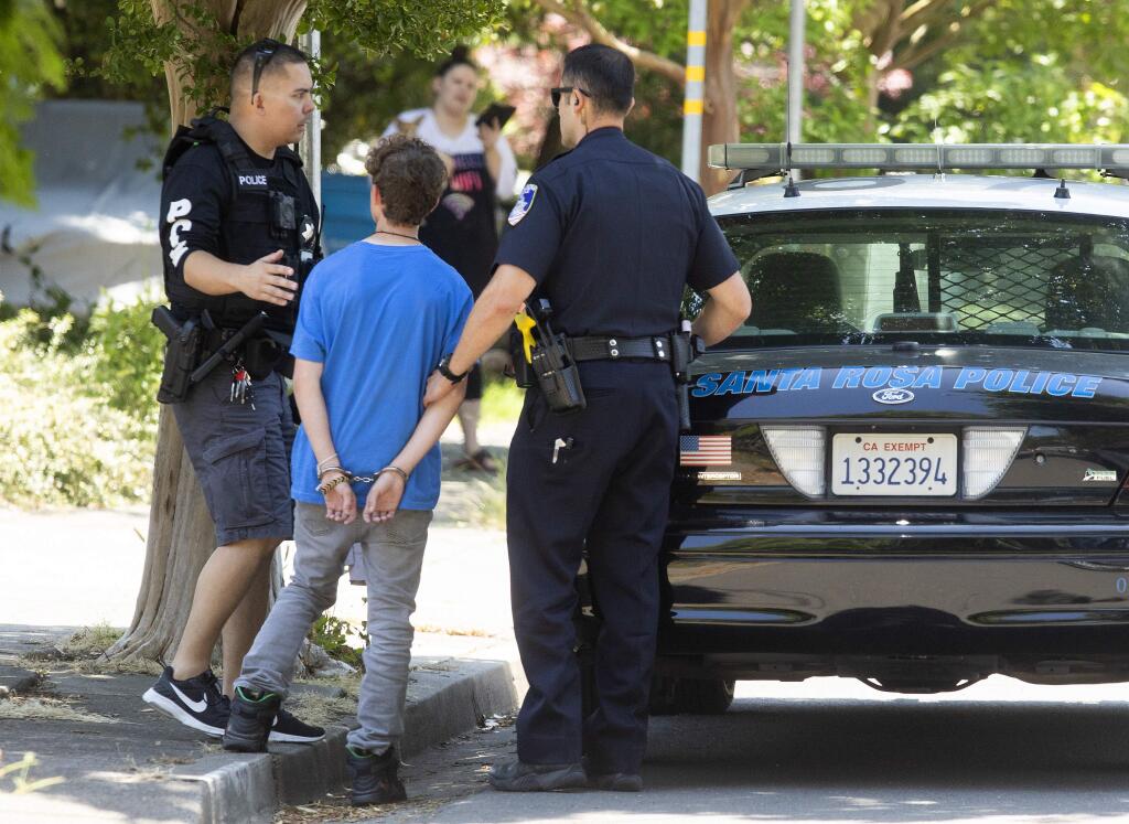 Santa Rosa Police officers detain a Santa Rosa High School freshman suspected of bringing a gun to the campus on Friday morning. The 15-year-old suspect was taken into custody on Beaver St. at about 1 p.m (photo by John Burgess/The Press Democrat)