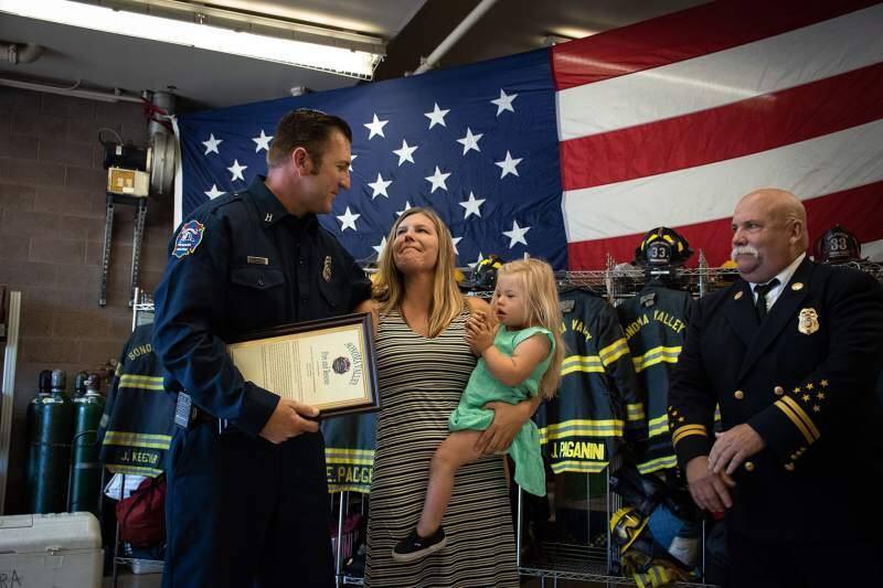 Sonoma Valley firefighter Gary Johnson, here with a 4-year-old girl he saved from choking, and her mother, was honored this summer at the Al Mazza Fire Station.