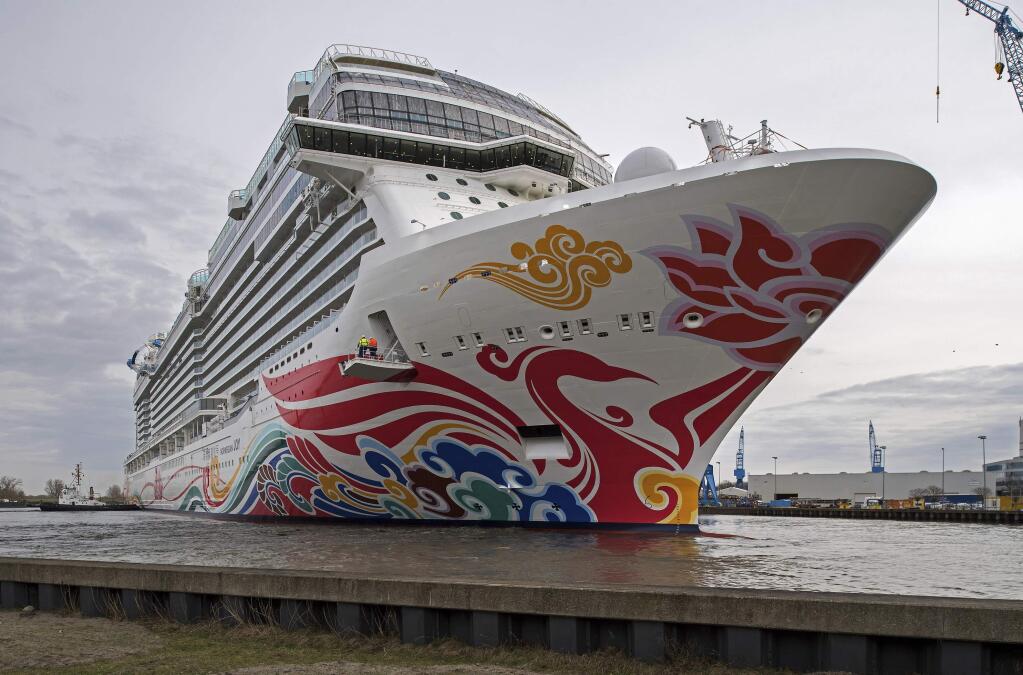 FILE - In this March 4, 2017, file photo, Norwegian's cruise liner 'Joy' floats out of the Meyer shipyard's building dock in Papenburg, northern Germany. Authorities say over a dozen people aboard the cruise ship reported flu-like illnesses as they reached a Southern California port. The Los Angeles Fire Department says authorities were called early Sunday, Dec. 1, 2019, to evaluate patients after they fell ill onboard. Authorities say the patients were evaluated and declined to be taken to the hospital. (Ingo Wagner/dpa via AP, File)