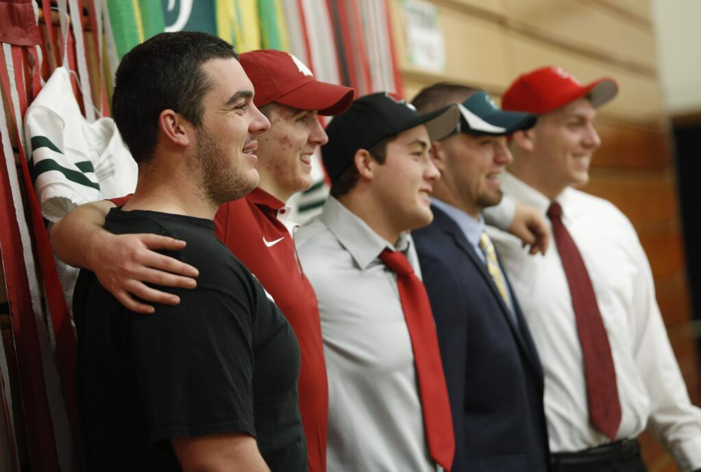From left, Casa Grande senior football players Peter Parrick, Matt Abramo, Brendan Jackson, Casey Longaker and Greg Poteracke pose for a photo after all but Parrick signed their National Letters of Intent in 2015. (BETH SCHLANKER / The Press Democrat)