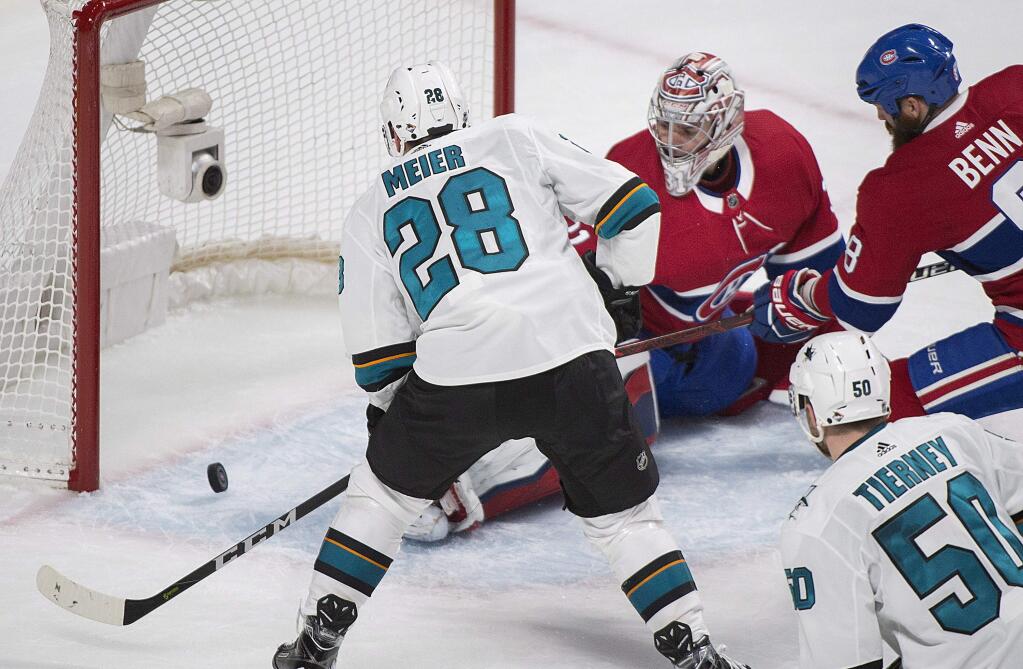 San Jose Sharks' Timo Meier (28) scores against Montreal Canadiens' Carey Price as Canadiens' Jordie Benn (8) and Sharks' Chris Tierney look for the rebound during the second period of an NHL hockey game in Montreal, Tuesday, Jan. 2, 2018. (Graham Hughes/The Canadian Press via AP)