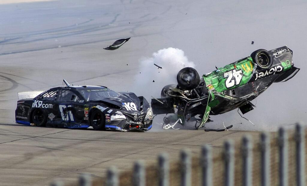 FILE - In this April 28, 2019, file photo, Kyle Larson (42) flips as he makes contact with Jeffrey Earnhardt (81) on the back stretch during a NASCAR Cup Series auto race at Talladega Superspeedway in Talladega, Ala. The Associated Press looks at some of the events that would have been live the week of April 20-26: A big one at Talladega Superspeedway. Chase Elliott won last April ahead of a race-ending crash that flipped Kyle Larson a half-dozen times. Larson was fired last week by Chip Ganassi after using a racial slur during a live-streamed virtual race. (AP Photo/Greg McWilliams, File)