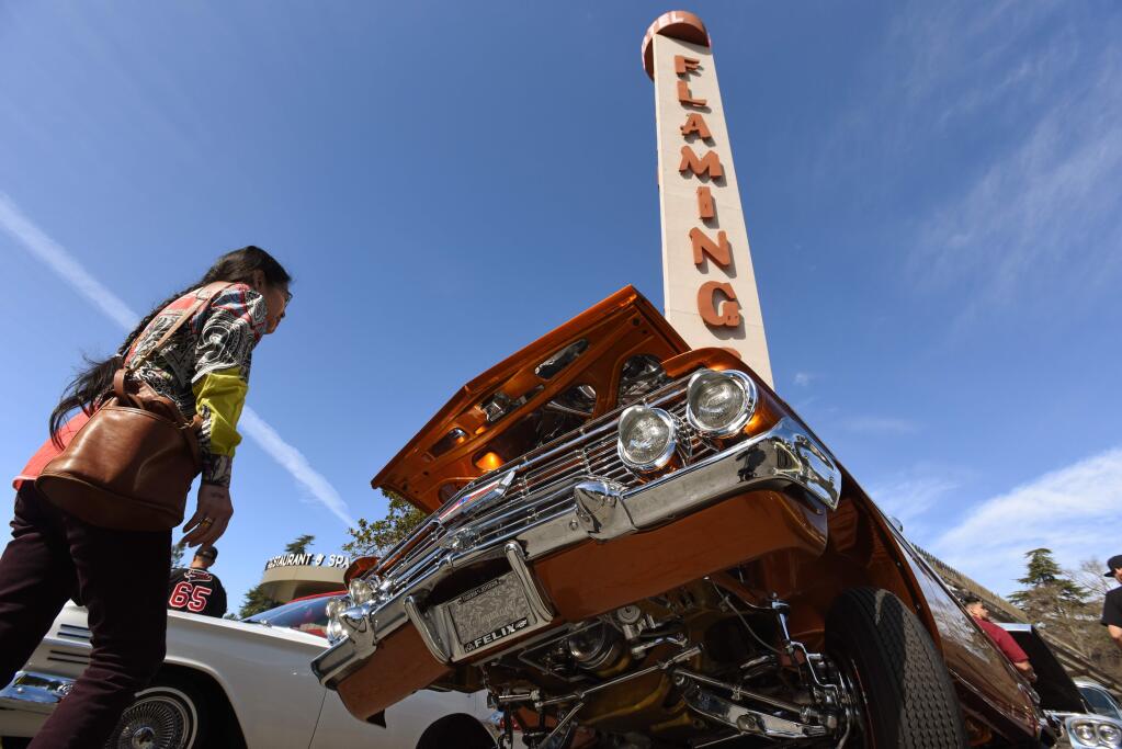 “These are some beautiful ones,” said Lynne Chao, left, of Hopland, California while looking over a 1961 Chevy Impala at the 29th annual Santa Rosa Tattoos and Blues event held at the Flamingo Resort & Spa in Santa Rosa, California, on Saturday, February, 29, 2020.(Photo: Erik Castro/for The Press Democrat)