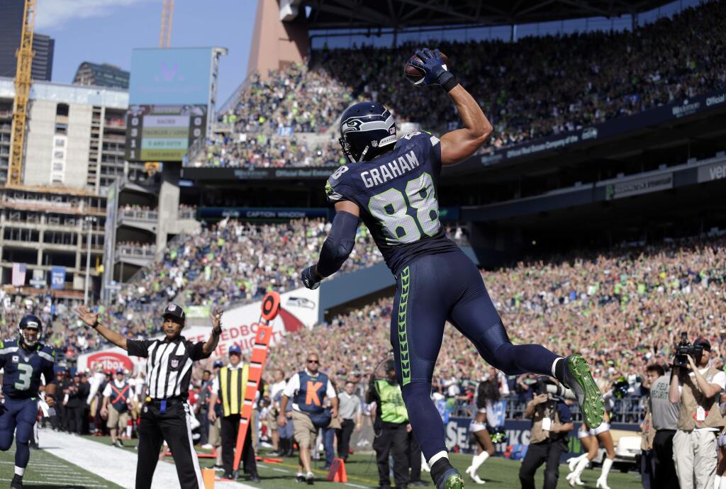 Seattle Seahawks' Jimmy Graham (88) leaps in celebration after scoring a touchdown against the San Francisco 49ers in the first half of an NFL football game, Sunday, Sept. 25, 2016, in Seattle. (AP Photo/John Froschauer)