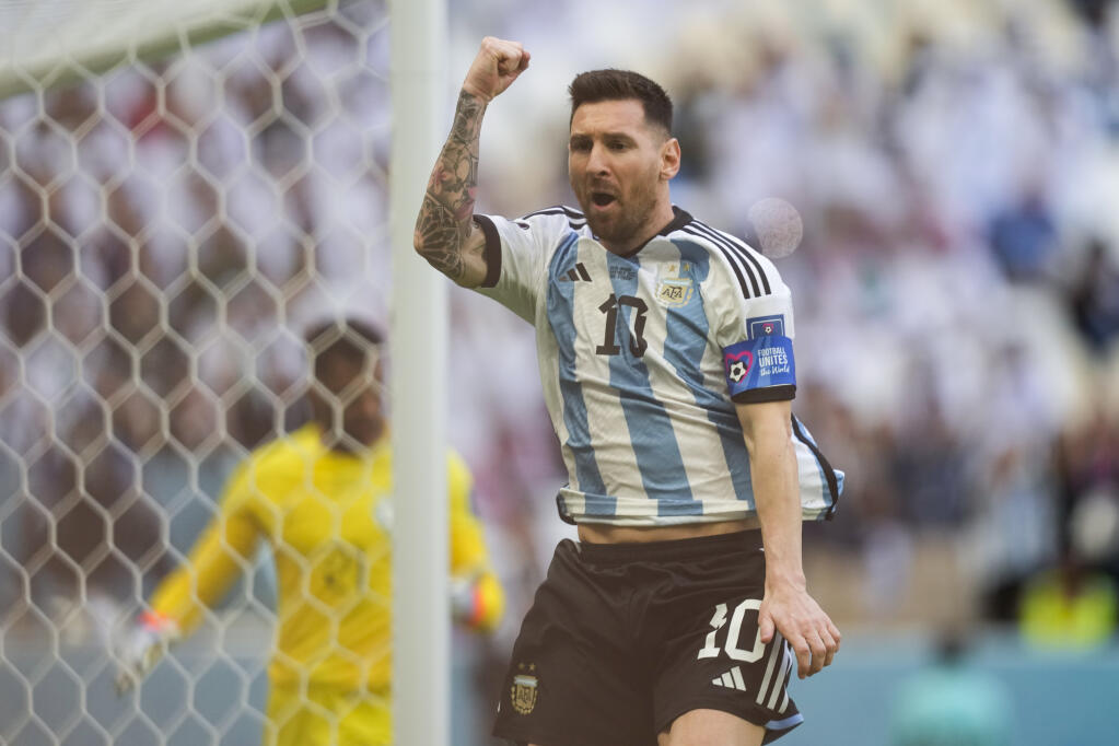 Argentina's Lionel Messi celebrates after scoring from the penalty spot his side's opening goal during the World Cup group C soccer match between Argentina and Saudi Arabia at the Lusail Stadium in Lusail, Qatar, Tuesday, Nov. 22, 2022. (AP Photo/Jorge Saenz)