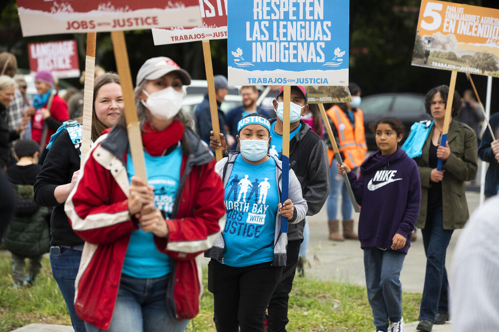 Maria Salinas, center, joined other farmworkers and their supporters to protest in front of the Sonoma County board of supervisors chambers on Monday April 18, 2022, to support changes to farmworker rights including language justice, hazard pay, and disaster Insurance and a formal evacuation zone policy.  (John Burgess/The Press Democrat)