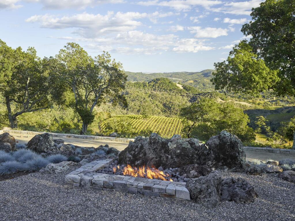 Marion Brenner / Roche + Roche Landscape ArchitectureThe home on a hillside above the Sonoma Valley has a gravel terrace with gas fire pit utilizing existing volcanic rock as a backdrop overlooking a bocce court and vineyards.