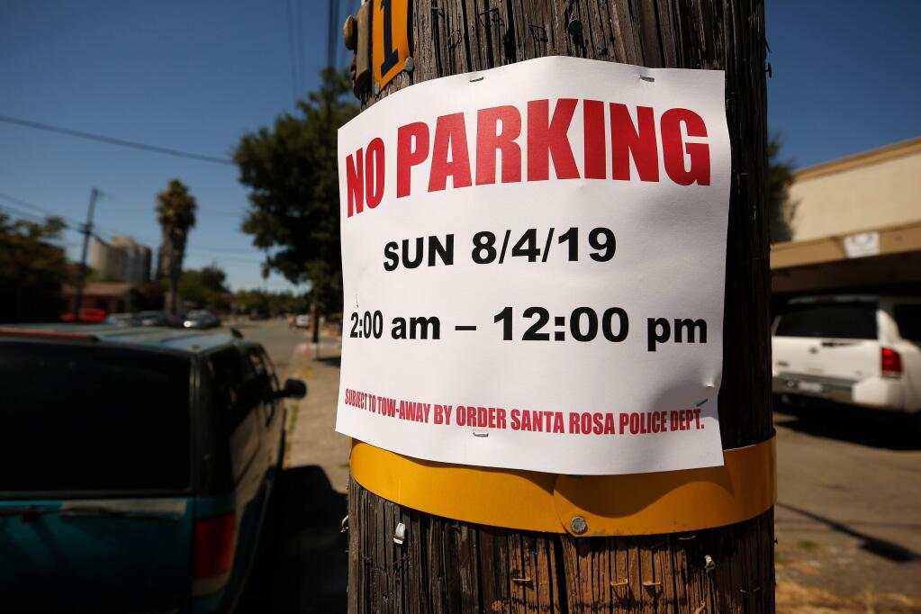 A no parking sign is stapled to a utility pole on South E Street during the Sonoma County Fair in Santa Rosa, California, on Saturday, August 3, 2019. (Alvin Jornada / The Press Democrat)