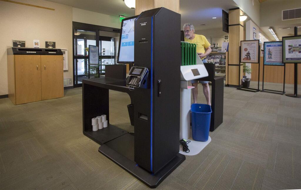 Two new check-out kiosks, back-to-back, at the Sonoma Valley Regional Library. (Photo by Robbi Pengelly/Index-Tribune)